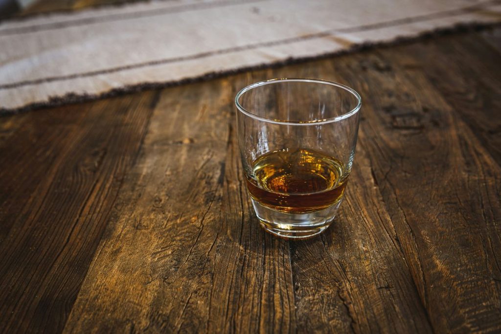 Photo by <a href="https://unsplash.com/@bluzninja?utm_source=unsplash&utm_medium=referral&utm_content=creditCopyText">phil cruz</a> on <a href="https://unsplash.com/photos/a-glass-of-whiskey-sitting-on-a-wooden-table-m2GdiC1r0WA?utm_source=unsplash&utm_medium=referral&utm_content=creditCopyText">Unsplash</a>